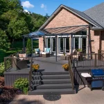 a Clubhouse PVC Ironwood deck with a grill and a glass roof
