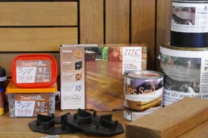 a group of wood pieces and cans of paint