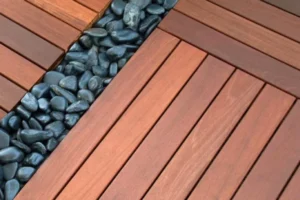 a ipe wood deck tiles with black rocks