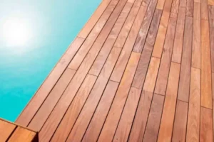 a wood ipe decking with a pool in the background