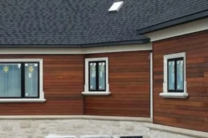 a house with a ipe siding and a white brick wall