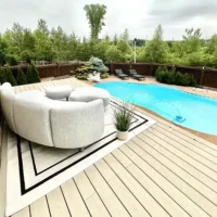 Modern composite decking with pool and seating.