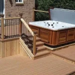 a hot tub on a TruNorth Enviroboard Caramel composite deck in golden-brown tone with authentic woodgrain finish.