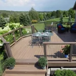 a TruNorth Enviroboard Tigerwood composite deck with bold russet brown streaks and natural hardwood appearance with a table and chairs