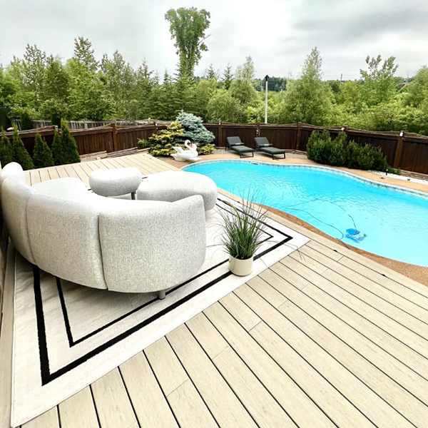 a pool with a woodbridge pvc deck and a couch