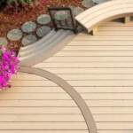 a timbertech brownstone harvest pvc deck with a curved bench and flowers