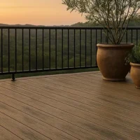 a woodbridge pvc, canadian walnut color deck with potted plants and a railing